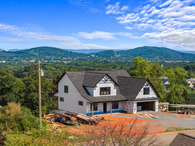 view of front of property with a mountain view and a garage