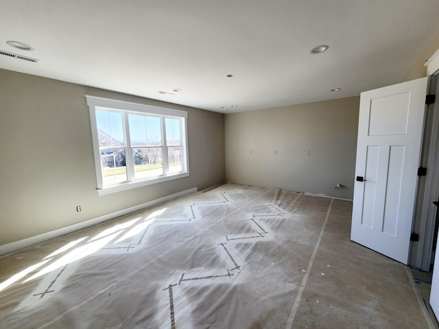 unfurnished room with visible vents