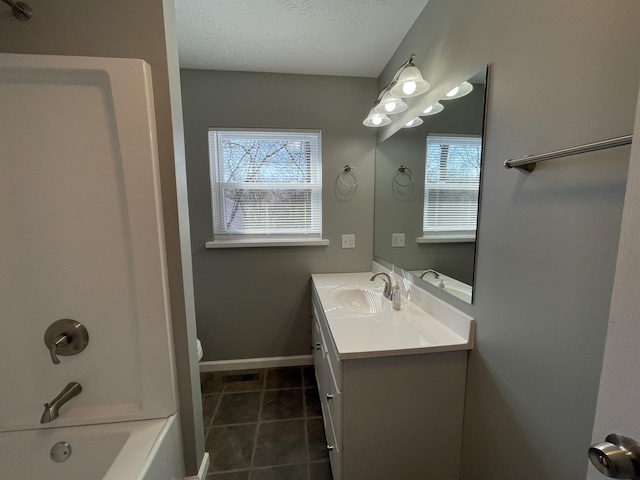 full bathroom featuring tile patterned floors, shower / bath combination, a textured ceiling, toilet, and vanity