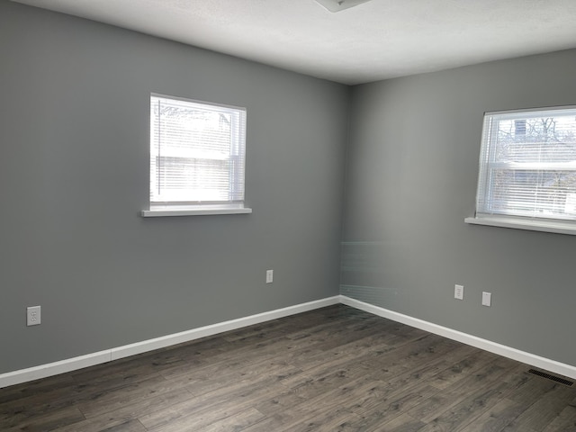 empty room featuring dark hardwood / wood-style floors