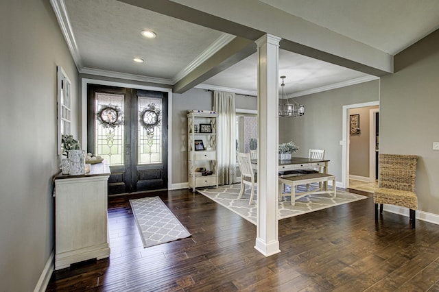 entryway with french doors, ornamental molding, dark hardwood / wood-style floors, and a notable chandelier