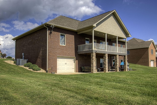 rear view of property with central AC, a yard, a balcony, and a garage