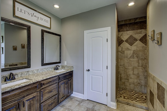 bathroom featuring vanity and tiled shower