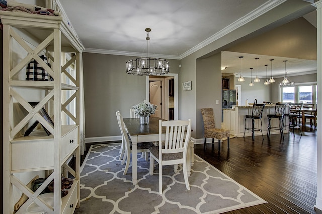 dining space with ornamental molding, dark wood-type flooring, and a notable chandelier