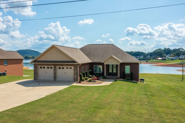 craftsman-style home with a front lawn, a water view, and a garage