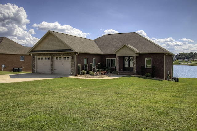 craftsman-style home featuring a garage and a front lawn