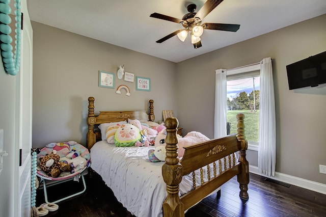 bedroom with ceiling fan and dark hardwood / wood-style flooring