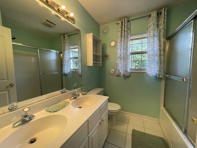 full bathroom featuring tile patterned flooring, vanity, bath / shower combo with glass door, and toilet