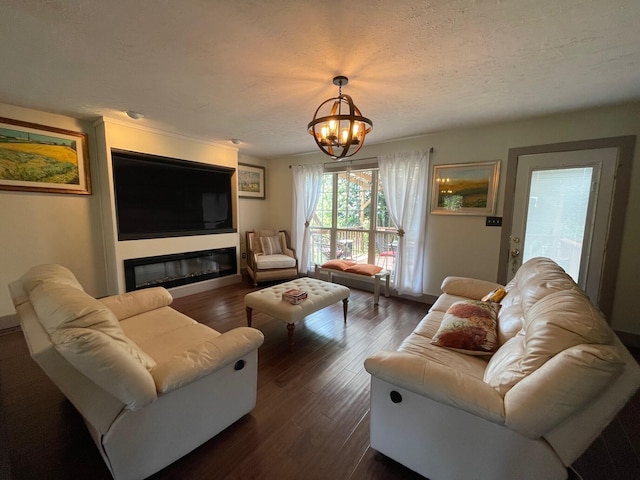 living room with a chandelier, a textured ceiling, and dark hardwood / wood-style flooring