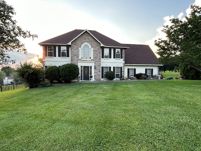 colonial home with a yard