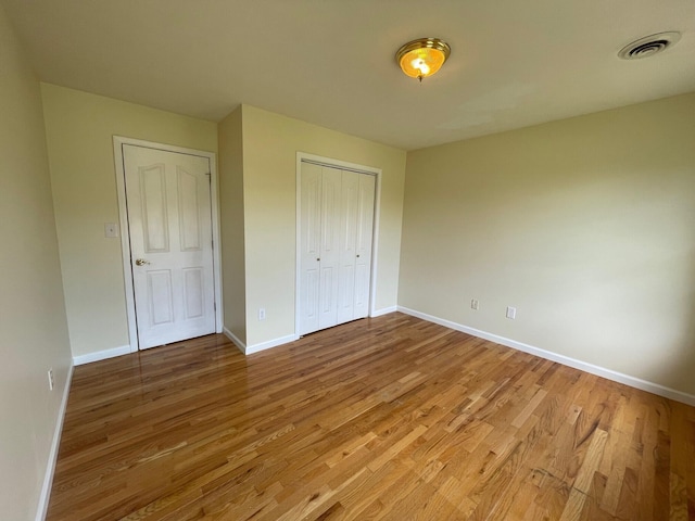 unfurnished bedroom featuring hardwood / wood-style flooring