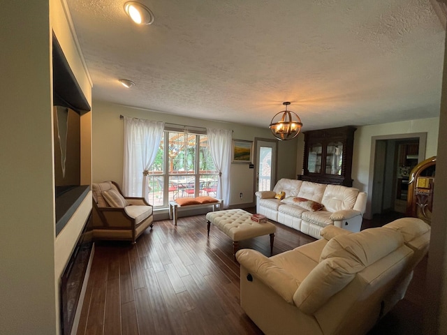 living room with a textured ceiling, dark hardwood / wood-style floors, and a notable chandelier