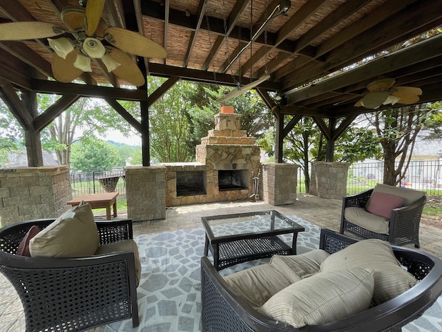 view of patio / terrace with an outdoor living space with a fireplace and ceiling fan