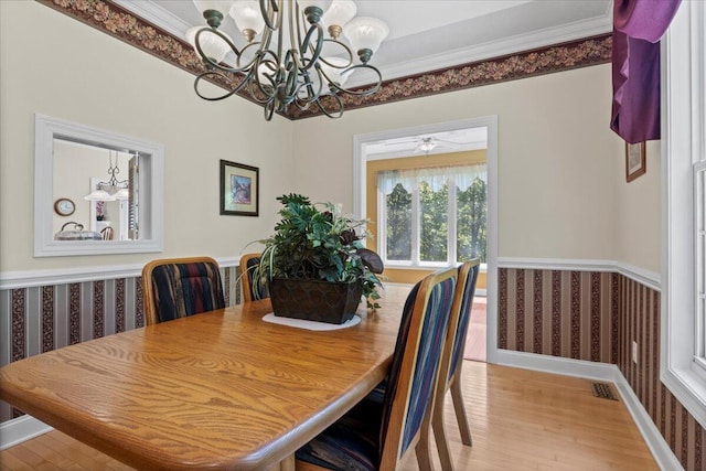 4018 Eagles Nest Dr, Morristown, TN 37813 - dining area featuring wallpapered walls, light wood-style flooring, a chandelier, ornamental molding, and wainscoting
