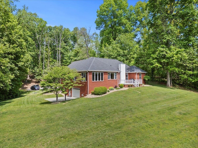 4018 Eagles Nest Dr, Morristown, TN 37813 - back of house with a garage, brick siding, a yard, and driveway