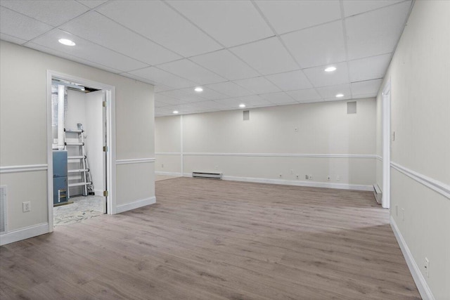4018 Eagles Nest Dr, Morristown, TN 37813 - finished basement with a baseboard heating unit, wood finished floors, recessed lighting, baseboards, and a drop ceiling