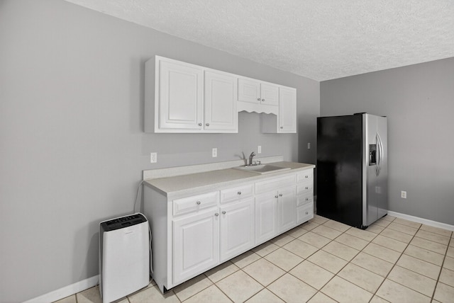 792 Hopper Blf, Rutledge, TN 37861 - kitchen with stainless steel refrigerator with ice dispenser, light countertops, a textured ceiling, white cabinetry, and light tile patterned floors