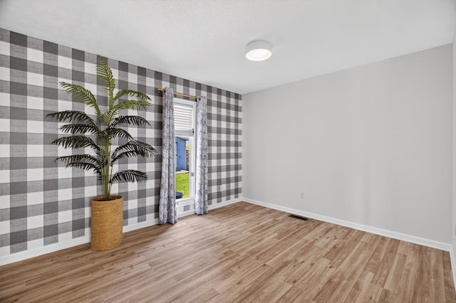 792 Hopper Blf, Rutledge, TN 37861 - empty room featuring wallpapered walls and light wood-style flooring