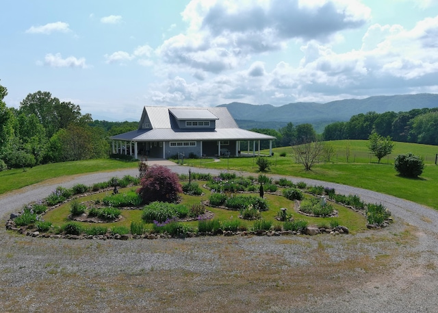 7545 Cedar Creek Rd, Greeneville, TN 37743 - farmhouse-style home with curved driveway, a front yard, a garage, a mountain view, and a metal roof