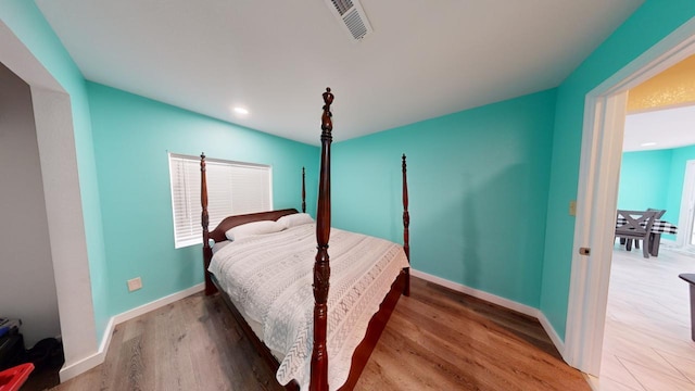 bedroom with hardwood / wood-style floors