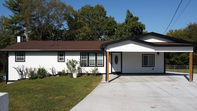 ranch-style house with a front yard and a carport