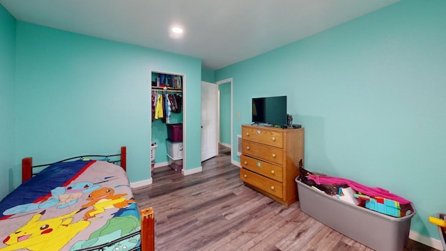 bedroom featuring wood-type flooring and a closet