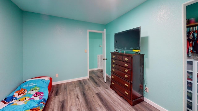 bedroom with hardwood / wood-style flooring