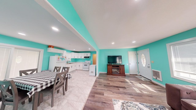 dining area with light hardwood / wood-style floors and sink