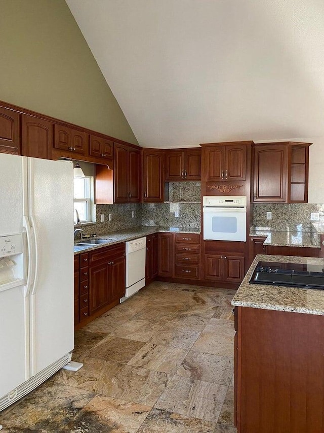 kitchen featuring white appliances, light stone counters, high vaulted ceiling, backsplash, and sink