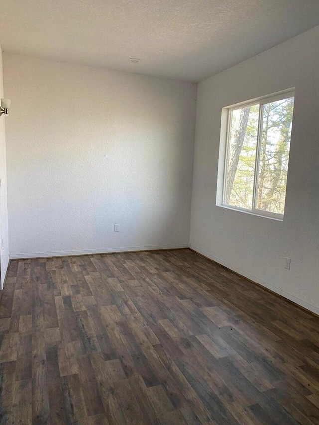 unfurnished room with dark hardwood / wood-style floors