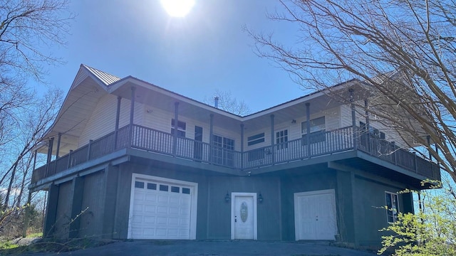 exterior space featuring a balcony and a garage