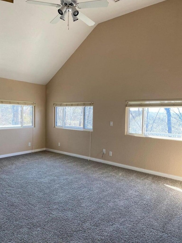 spare room featuring ceiling fan, a healthy amount of sunlight, carpet floors, and lofted ceiling