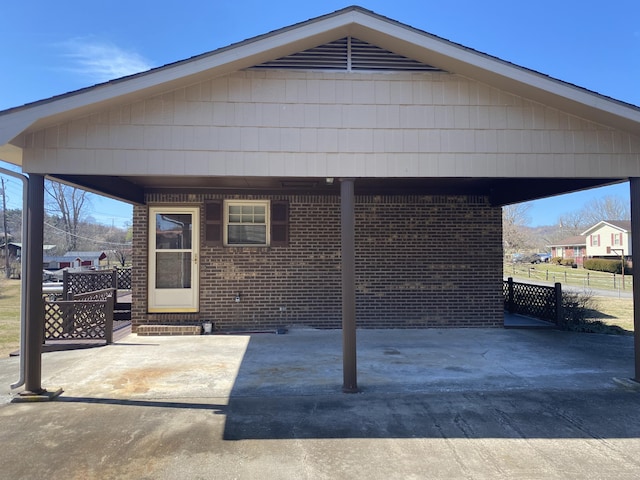 exterior space featuring brick siding and fence