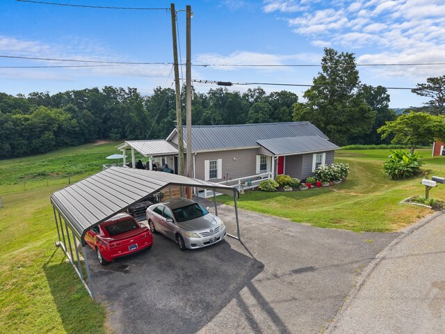 1438 Shannons Little Mtn Rd, Morristown, TN 37814 - view of front of property with a metal roof, a detached carport, a front yard, and asphalt driveway