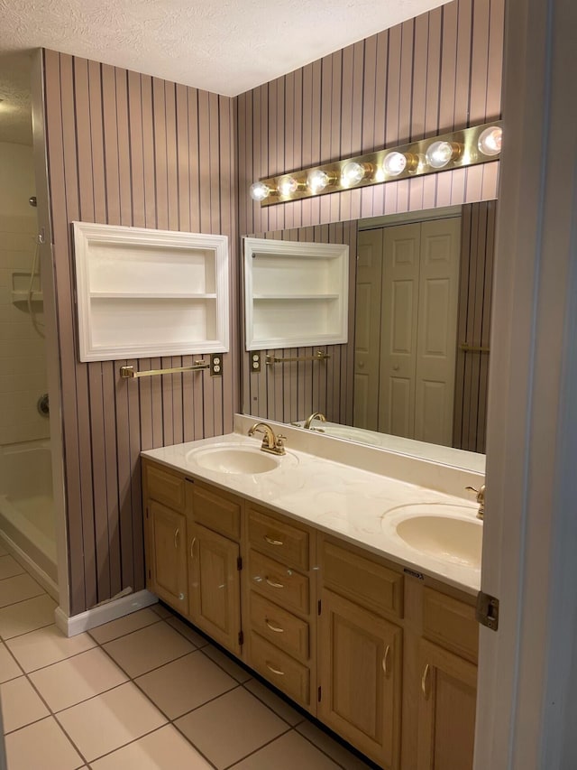 1412 Secreretariat Dr, Morristown, TN 37814 - bathroom featuring tile patterned floors, a textured ceiling, double vanity, and shower / tub combination