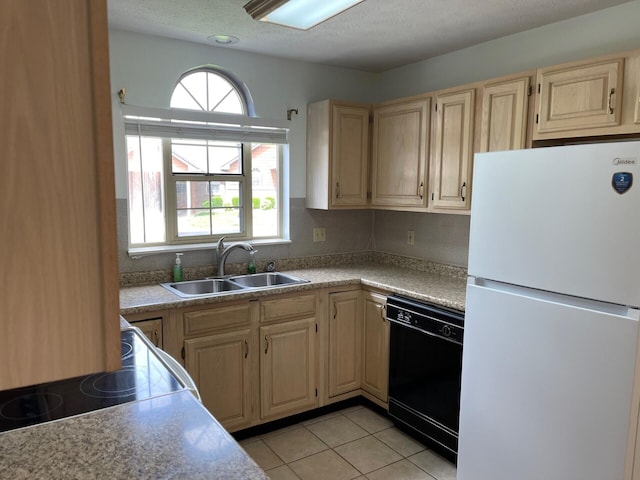 1412 Secreretariat Dr, Morristown, TN 37814 - kitchen with freestanding refrigerator, black dishwasher, a sink, light brown cabinetry, and light countertops