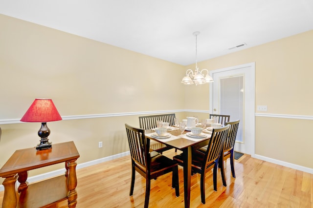 dining space featuring a notable chandelier and light hardwood / wood-style flooring