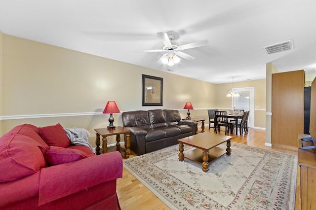 living room with ceiling fan and hardwood / wood-style flooring