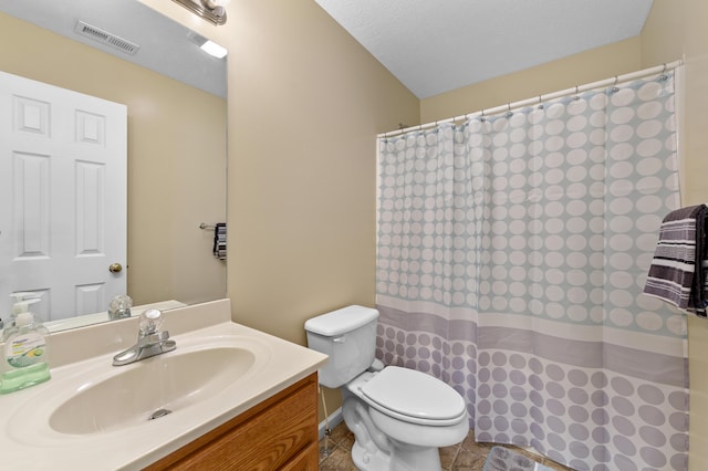 bathroom featuring toilet, a textured ceiling, and vanity