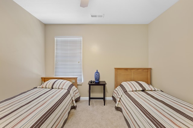 bedroom featuring light carpet and ceiling fan