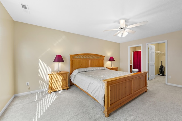 carpeted bedroom with ceiling fan, a closet, a spacious closet, and connected bathroom