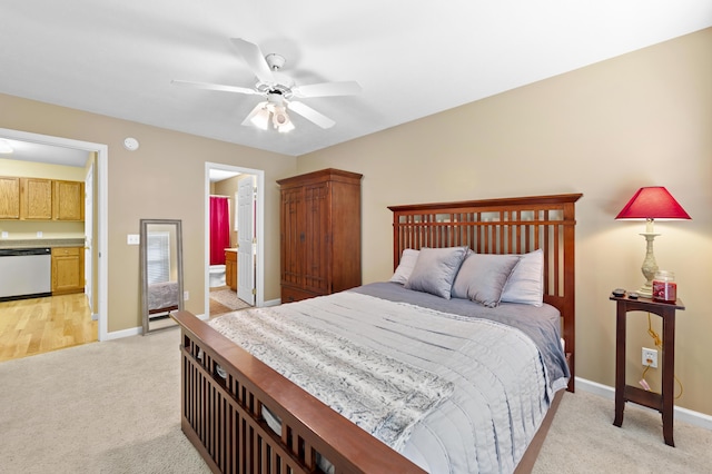 carpeted bedroom featuring ceiling fan and ensuite bath