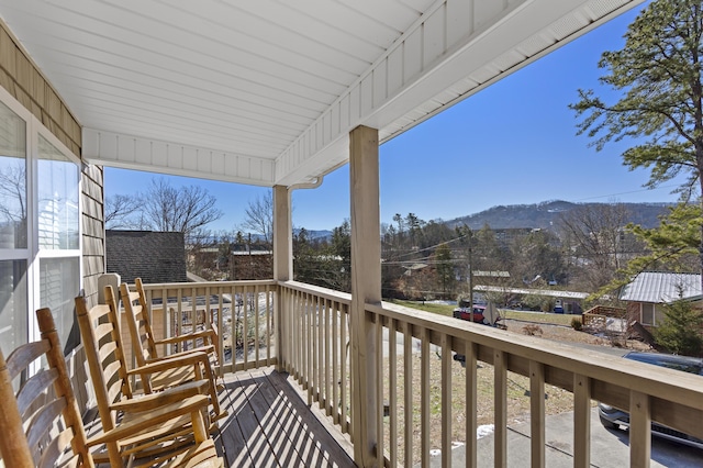 balcony with a mountain view and a porch