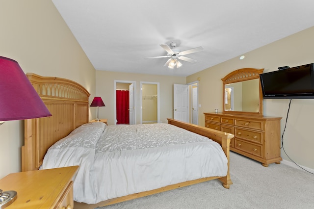 carpeted bedroom with ceiling fan, a closet, and a spacious closet