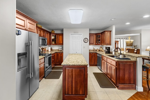 5704 Long Creek Rd, Morristown, TN 37813 - kitchen with appliances with stainless steel finishes, a peninsula, a center island, a chandelier, and glass insert cabinets