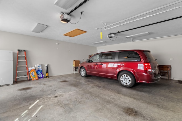 5704 Long Creek Rd, Morristown, TN 37813 - garage with freestanding refrigerator and a garage door opener