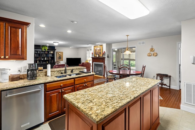5704 Long Creek Rd, Morristown, TN 37813 - kitchen with stainless steel dishwasher, a fireplace, a peninsula, light stone countertops, and recessed lighting