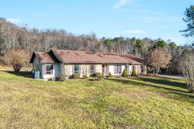 ranch-style home featuring central AC and a front lawn