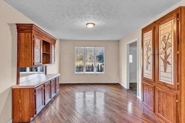 interior space featuring light hardwood / wood-style flooring and a textured ceiling