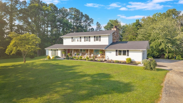 1216 Winding Dr, Sevierville, TN 37876 - view of front of home with covered porch, a chimney, a front yard, and driveway